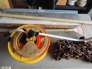 lot 323 image: Misc. yard lot- wooster sherlock pole, small metal garden rake, extension cord rollar, sledge  hammer, paint shield large heavy tow chain
