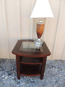 lot 7 image: Side table HAS  2 shelves with glass top AND A  LAMP  with brown wood  and silver extra plug in base with white shade
