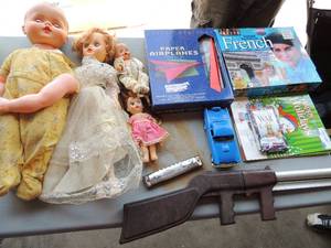 lot 55 image: Learn French CD set language book, Paper airplne book war cards, air fire submachine gun harmonica, various baby dolls 1 needs arm repair