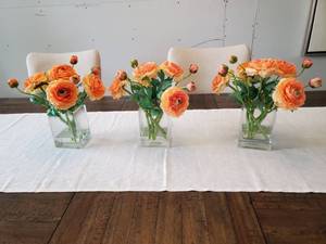 lot 33 image: Three Faux Orange Flowers in Glass Vases