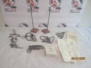 lot 34 image: TOTAL OF 5 ANTIQUE&nbsp TAVERN METAL&nbsp PUZZLE&nbsp COLLECTION BRAIN TEASERS WITH 2 WOOD BASE DISPLAY STANDS FOR HANGING PUZZLES&nbsp