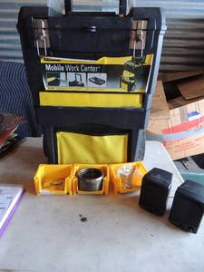 lot 456 image: Mobile work center, tool box black and yellow, batton ports con all includes 2 small stackable tool holders and clock kit repair pieces.