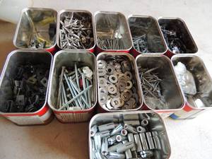 lot 386 image: Small coffee cans of (organized by product) screws, nails, spacers and clamps