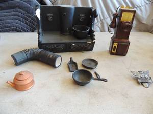 lot 402 image: Ceramic wood burning stove comes with pots and pans. Small broken pieces but they are included for repair and antique phone music box