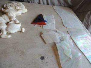 lot 406 image: Porcelain doll with water bucket and small cotton candy color stained glass pieces