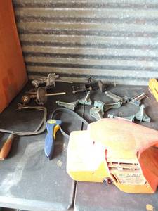 lot 381 image: 4 Belt sander 120 volt grip wrench , 2 paint spray guns, hand saw blades various size levels