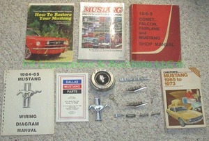 lot 5 image: Genuine 1965 Ford Mustang emblems with Mustang repair and parts books