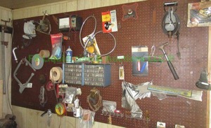 lot 396 image: Contents of wall including tools and hardware