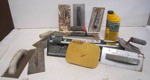 lot 129 image: Tile cutter, trowels, sealer and grout