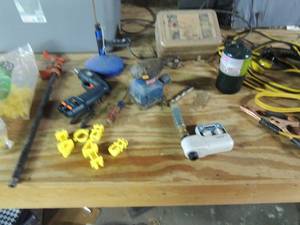 lot 482 image: Used bag of T-post insulators, Ryal sander, Black n Decker  drill no charger, Coleman propane lantern can, 2 sets of jumper cables, Range master electric fence charger and more