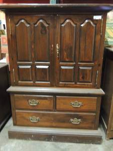lot 590 image: Ethan Allen Entertainment center 3 drawers at the bottom double doors at time 1 door missing handle other door needs hinge repair 56x51 20 deep