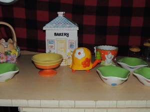lot 493 image: Porcelain Easter basket by Teleflora Bakery covered cookie jar , 4 polka dot century dessert bowls, 2 small jars with pie lids, porcelain turtles, 3 bunny egg candy dish I ear broken