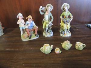 lot 662 image: Porcelain people set carrying fruit baskets and more, mini tea set with pot sugar creamer and 1 teacup.