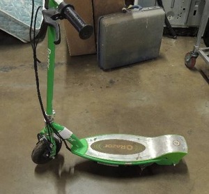 lot 676 image: Green electric razor scooter charger not included but available for purchase on amazon