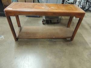 lot 679 image: Brown wooden table with a few scratches on top in good shape 52 x 17 x 27 high