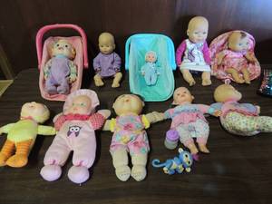 lot 690 image: 2 baby doll car seats with pink backpack baby carrier, assorted baby dolls and cabbage patch dolls.