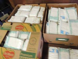 lot 699 image: 3 banana boxes full of size 4 sample diapers with single wipe