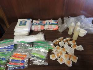 lot 704 image: 13 six oz. baby bottles, 26 disposable nipples, 2 Angel of mine baby washes, 1 head to toe Johnson  Johnson baby soap, 1 packs of cloth diapers 10 in each, 2 girl blankets, 20 plus baby spoons, 15 wash clothes and Gerber Sippy cup