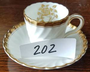 lot 202 image: VINTAGE MINTONS (ENGLAND) GOLD ROSE DEMITASSE CUP AND SAUCER SET