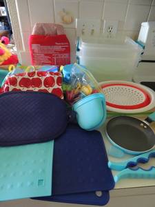 lot 42 image: Silicone mats, oven mits, jar opener, collapsible bowl, small boxes, clips, potato express, aprons and 4  skillet