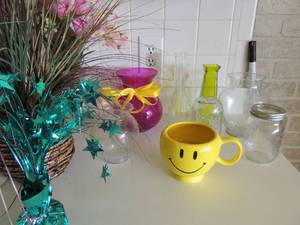 lot 50 image: Various vases, clear glass, green vase wicker basket planter smiley face cup vase