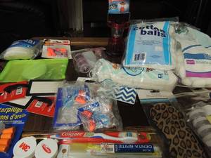 lot 102 image: Travel makeup mirror, disposable ear plugs, mini lantern, cotton balls, travel size bottles, new eye ask, new luggage tags, toothbrushes and more