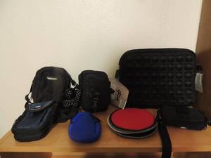 lot 116 image: several fanny packs, camera bags with one table cover