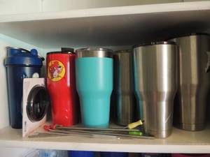 lot 17 image: Insulated cups Timberland and Yeti total 7  also metal straws and plastic tumblers