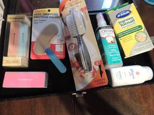lot 239 image: Foot care lot-Shoe heel grips, Crystal foot Oder spray, baby powder, Foot exfoliator paddle 7 way nail buffer