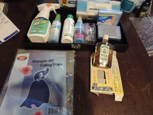 lot 235 image: Q tips, eyeglass repair kit , downy wrinkle release Moisturizer, fabreeze to go, odercide, fabric refresh, hairdresser cutting cape, woodblock Chinese remedy