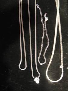 lot 216 image: Sterling silver chains 16,   16,    20 herringbone sterling silver chain with silver cross