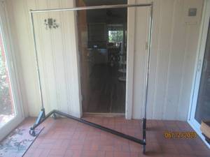 lot 110 image: ROLLING GARMENT RACK WITH LOCKING WHEELS