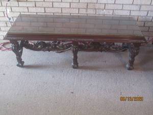 lot 141 image: COFFEE TABLE WITH ELABORATE CARVED BASE AND STRETCHER52 L X 19 X 18 H