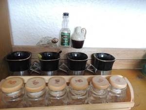lot 36 image: 6 tortellinis jars with lids, set of 4 black cups with silver bottoms from Japan, Wolf Schmidt vodka bottle, glass turtle perfume bottle with golden head  top