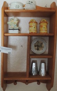 lot 40 image: A silver flowered S&P shaker, A Carlsbad caverns small plate, Hobby Lobby garden snow dcor, tiny Irish pottery cup, a half side cup with horse dcor, a yellow brown and pink glass basket S&P shaker brown shelf with the bottom hooks
