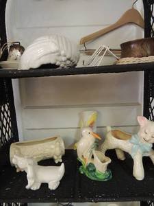 lot 49 image: White shell container, a rusty bell, Iowa bread plate covered in red flowers, 2 gold saucers, a wooden bowl a woven picture frame, Bellini glass collectable dog, glass lamb with blue bow tie and glass bird in tall grass