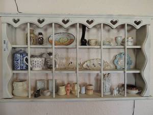 lot 106 image: Wall shelf  35x29 x5  with HAEGAR BOOT, COOKS NIP, various decanters, PITCHER RURAL SCENERY, creamer KINGS ROW, small angels, cats, ,  and more