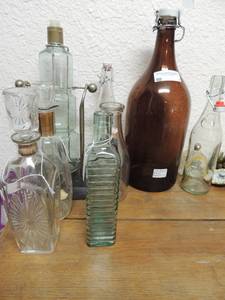 lot 7 image: 7 dcor bottles-wasabryageriet Orebro klass1 green bottle with rippled glass, 2 1895 Geyer freres mason glass bottles, L-9918 glass bottle with a mini shot glass, Patrician triple stack glass stand