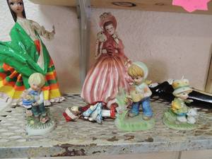 lot 9 image: Mexican dancer doll, pink glass vintage girl,4 small glass garden statues, a Liquor Galslslane soldier glass doll