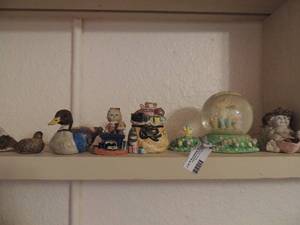 lot 156 image: Misc.- 3 small birds, child sitting at desk OCI Christmas Santa bag filled with toys and Easter snow globe