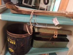 lot 183 image: Long fishing hooks on wooden stick and green metal tackle box