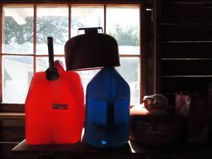 lot 307 image: Red 5 gallon gas can Blue 5 gallon gas can eagle 2.5 gallon metal can and 4 gallon can