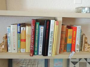 lot 424 image: Book lot and gold angel book ends- household hints, money secrets, food remedies and more