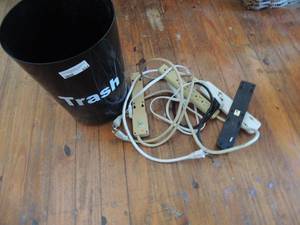 lot 454 image: Black trash can full of multiple power strips ( they all work)