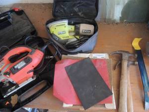 lot 486 image: Black and decker sabre saw, ryobi sander in case,  box of sandpaper,  hammer x 2, an nail bar