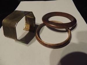 lot 525 image: 3 bracelets- 1 brass cuff, 2 wood bangle