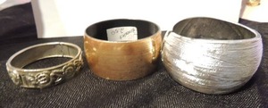 lot 511 image: 3 bracelets- 1 gold cuff, 1 silver cuff and 1 rose design bangle