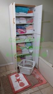 lot 236 image: Assorted bath linens and storage cabinet