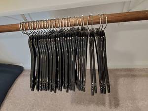 lot 186 image: 29 Black Wood Hangers with Metal Hanger