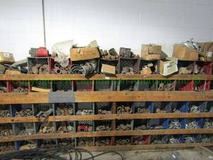 lot 61 image: Assorted industrial pipe fittings, pipe hanger straps and more as shown, very generous quantity